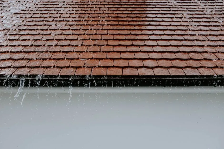 Rain running off a roof into the gutter